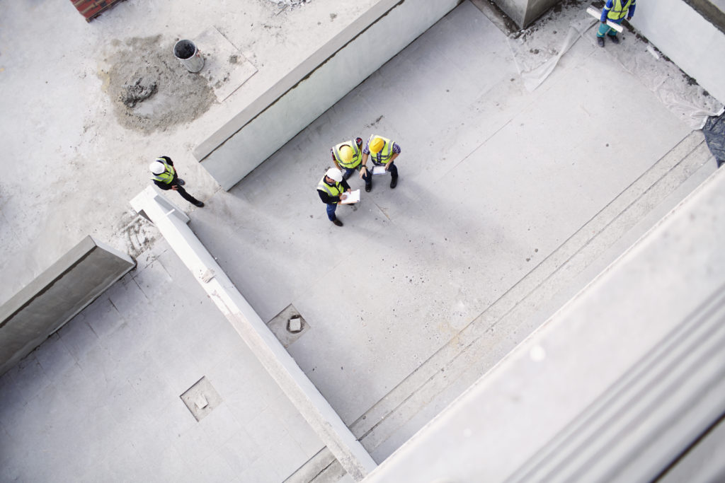 Overhead view of construction workers and engineers at construction